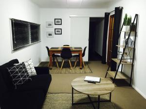 a living room with a table and a couch at Cottage on Cork Steadman Cottage in Winton