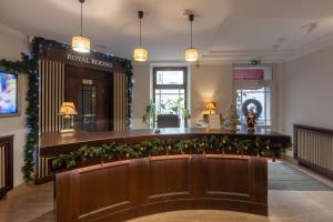 a lobby with a row of plants on a bench at Royal Rooms Self Check-in in Poznań