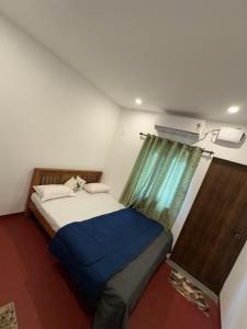 a small bedroom with a bed and a window at Azriel marari in Mararikulam