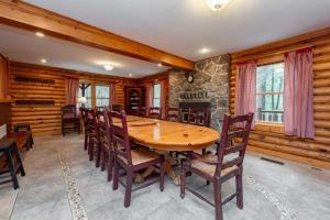 a dining room with a wooden table and chairs at Viva By The Stream by Railey Vacations in McHenry