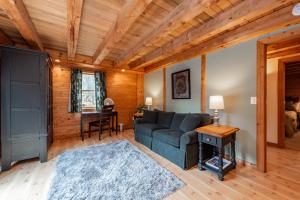 a living room with a couch and a table at Viva By The Stream by Railey Vacations in McHenry