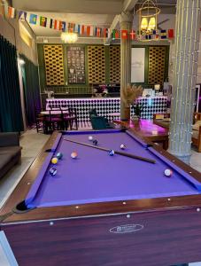 a pool table with balls on it in a room at You Empire Hostel & Bar in Pakse