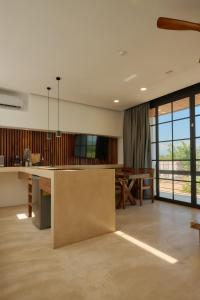 a large kitchen with a table and a dining room at Hotel Compartir in Brisas de Zicatela