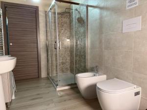 a bathroom with a shower and a toilet and a sink at La Dimora Certosina in Padula +29 photos