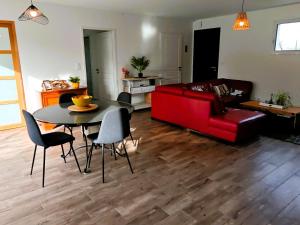 a living room with a red couch and a table at Tamaris Abba in Talmont
