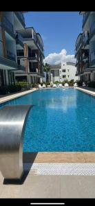 a large swimming pool in front of some buildings at Belek Room Voyage in Belek
