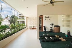 a balcony with a view of a living room at Manu Villas in Sanur