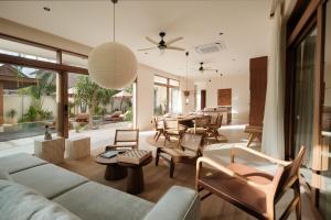a living room with a couch and chairs and a table at Manu Villas in Sanur
