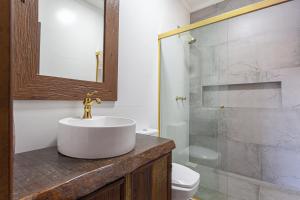 a bathroom with a sink and a shower at Casa de veraneio na Itapeva in Torres +25 photos
