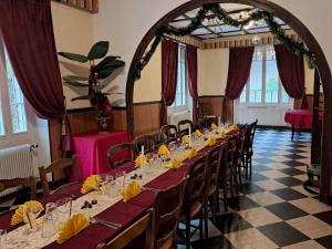 a dining room with a long table and chairs at Chalet de la source in Prades +61 photos