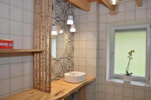 a bathroom with a sink and a mirror at Joz Une Halte in Saint-Antoine
