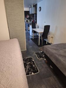 a bedroom with a bed and a table and chairs at Appartement Ons Plekje in De Wilp
