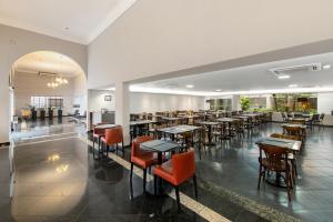 a restaurant with tables and chairs in a room at Slim Hotel São Paulo Congonhas in São Paulo
