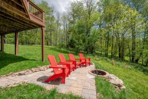 a row of red benches sitting on a brick path at The Cozy Perch by Railey Vacations in Oakland