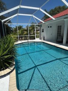 a large swimming pool with a white canopy over it at Villa Paloma in Cape Coral