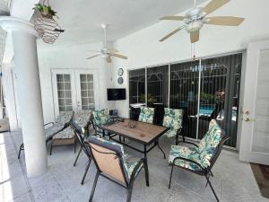a living room with a table and chairs at Villa Paloma in Cape Coral +24 photos