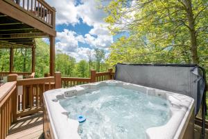 a hot tub on the deck of a house at The Cozy Perch by Railey Vacations in Oakland