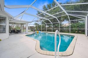 a swimming pool with a glass roof over it at Villa Yvonne in Cape Coral
