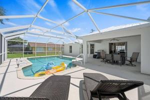 a swimming pool with a pool noodle in a house at Villa Yvonne in Cape Coral