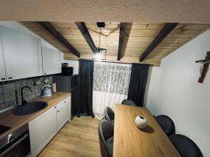 a kitchen with a table and chairs in a room at Planinski šapat in Blidinje