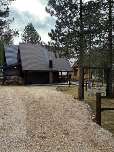 a barn with two solar panels on the side of it at Planinski šapat in Blidinje