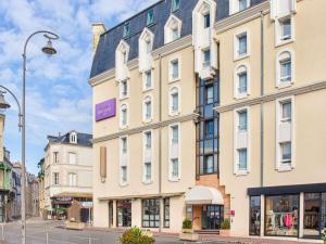 a large white building on a city street at Mercure Trouville Sur Mer in Trouville-sur-Mer
