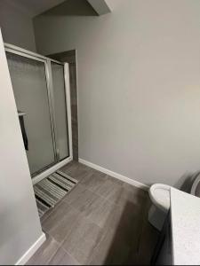 a bathroom with a shower and a toilet at Pond view Walkout in Airdrie