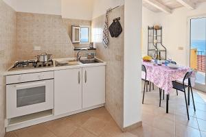a kitchen and dining room with a table with chairs at Parasio - Mareri apartments in Imperia