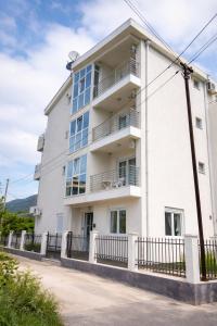a white building with a fence in front of it at Villa Swan in Bar