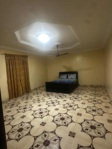 an empty room with a bed and a ceiling at BTourays Rentals in Yundum