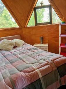 a bed in a room with two windows at Domo familiar campestre in La Montaña