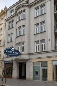 a hotel building with a sign in front of it at Royal Rooms Self Check-in in Poznań