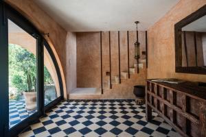 a room with a staircase and a checkerboard floor at Coco Lou - Private Villa with Rooftop Pool in Holbox Island