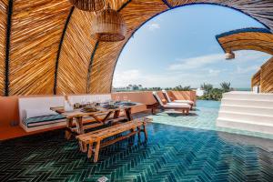 a room with a table and chairs in a yurt at Coco Lou - Private Villa with Rooftop Pool in Holbox Island