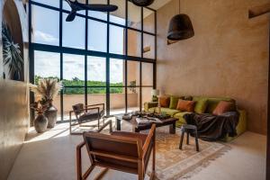 a living room with a couch and a table at Coco Lou - Private Villa with Rooftop Pool in Holbox Island