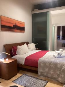 a bedroom with a bed with a red and white blanket at Apartment best Harbour view in Valletta +39 photos