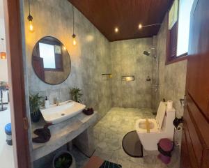 a bathroom with a sink and a toilet and a mirror at Ella Forest Eco View in Ella +109 photos