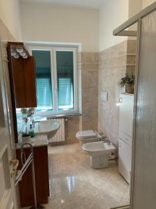 a bathroom with a toilet and a sink at Casa Riviera in Lavagna +19 photos