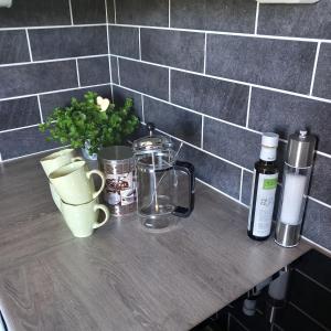 a counter top with cups and other items on it at Central functional apartment with short distance to everything in Sandefjord +8 photos