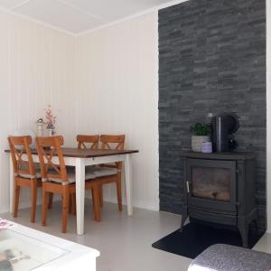 a dining room with a table and a stove at Central functional apartment with short distance to everything in Sandefjord