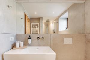 a bathroom with a white sink and a mirror at Chalet Hafling Leckplått in Avelengo