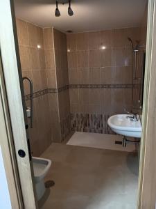 a bathroom with a toilet and a sink at EMMI Guesthouse in Alicante