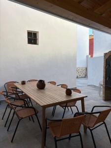 a wooden table and chairs in a room at La Ermita Casa Rural in Benablón
