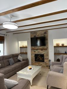 a living room with couches and a fireplace at La Ermita Casa Rural in Benablón
