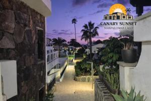 a view of the entrance to a resort at night at Maspalomas Lago Canary Sunset in Maspalomas