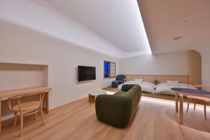 a large room with two beds and a television at Ureshino Onsen Yusyuku Sarayama in Ureshino