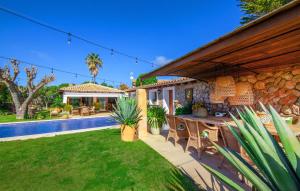 a house with a yard with a swimming pool and a patio at Can Sion in Esporlas