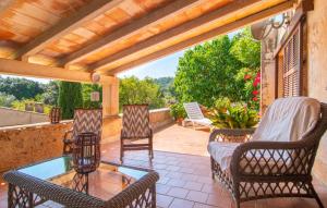 an outdoor patio with chairs and a glass table at Can Sua in Artá +34 photos