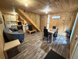a living room and kitchen with a table and a couch at Chalet Nala in La Bresse