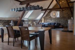 a dining room with a wooden table and chairs at Ferienhaus zum Brauneberg in Klotten
